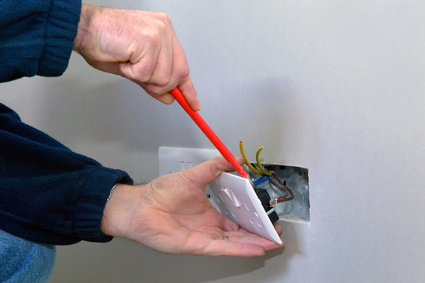 Electrician installing a plug.